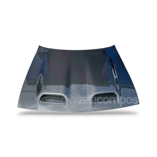 Carbon fiber hood section with two vent openings, glossy dark blue-black finish.