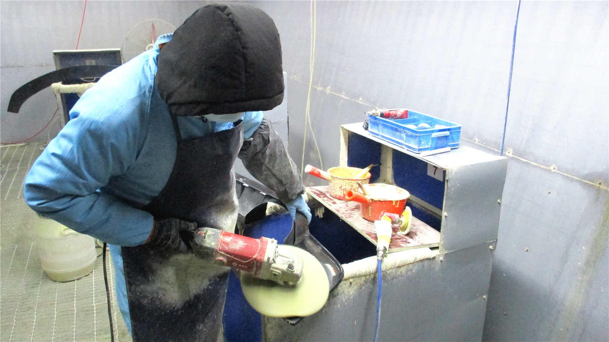 photo showcases a man polishing a carbon fiber diffuser with a polishing tool
