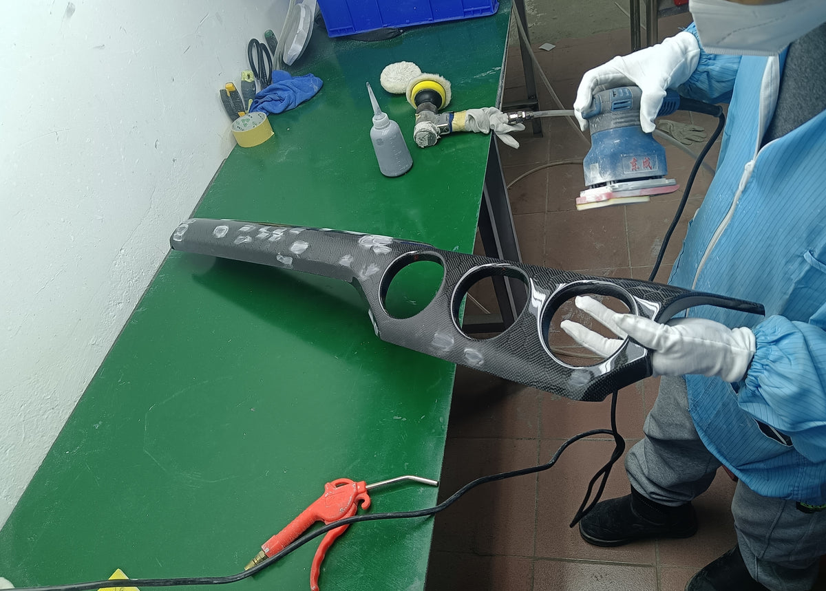 showcases a zetacomposites employee polishing a carbon fiber dash kit for a 2015-2023 s550 mustang with a polishing tool