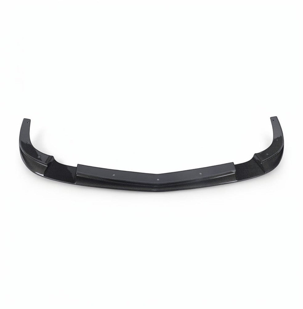 A black carbon fiber rear lip spoiler for a vehicle, shown against a plain white background.