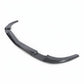 A curved carbon fiber automotive body part, likely a lip spoiler or rear diffuser, shown on a clean white background.