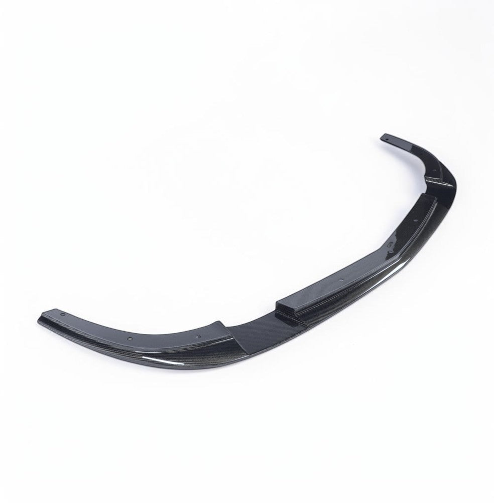 A glossy black carbon fiber rear lip spoiler for a car, shown on a clean white background.