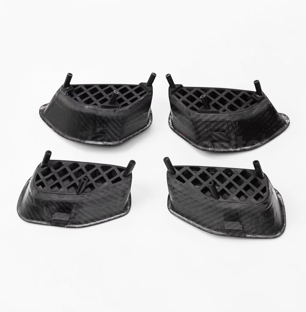 Four black carbon fiber textured protective covers arranged in a 2x2 grid on a white background.