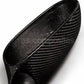Close-up of a black carbon fiber textured shoe or boot interior and side, showing the woven pattern on a white background.