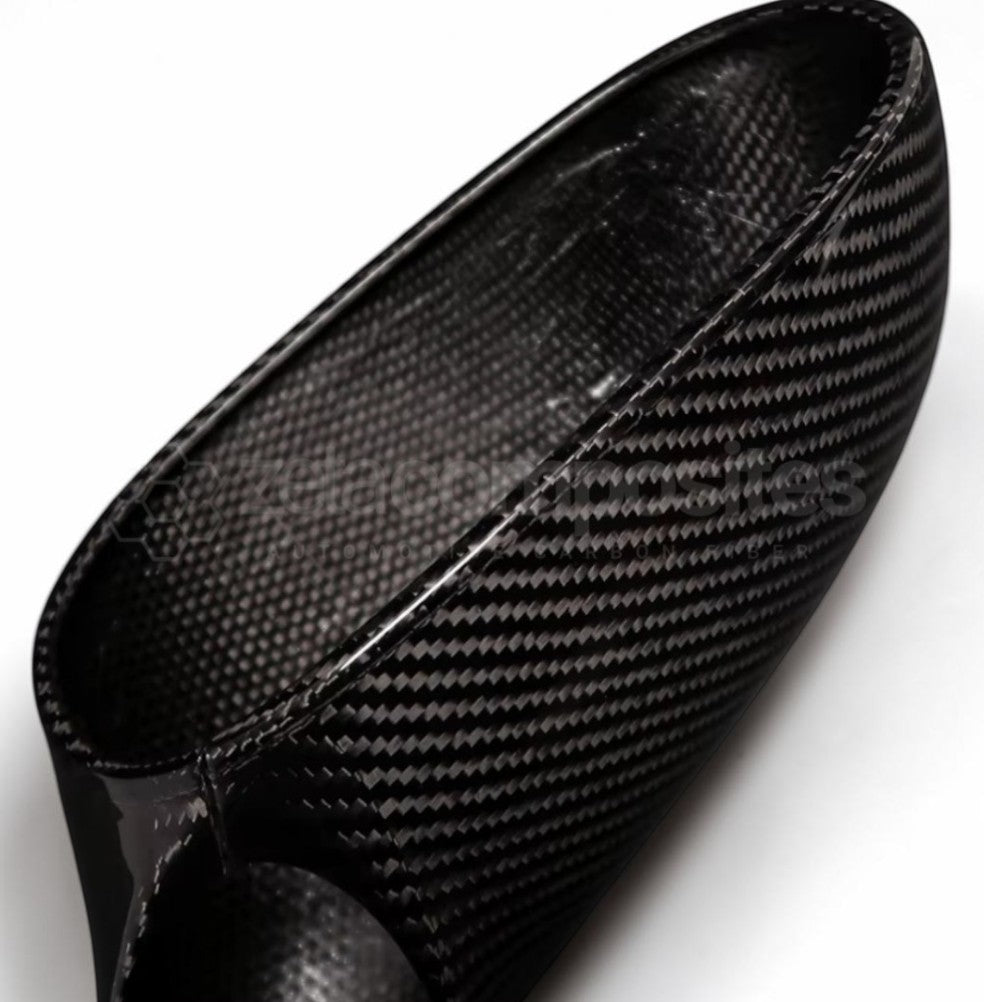 Close-up of a black carbon fiber textured shoe or boot interior and side, showing the woven pattern on a white background.