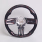 Carbon fiber steering wheel with black and red marbled trim and exposed central mounting hub