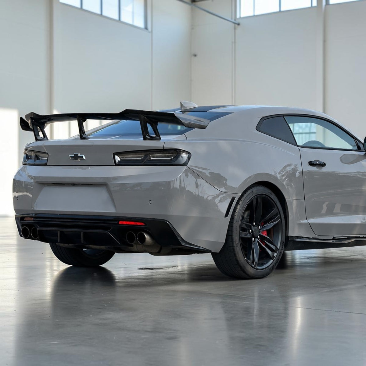Camaro rear wing spoiler with carbon fiber finish, raised center section and supports