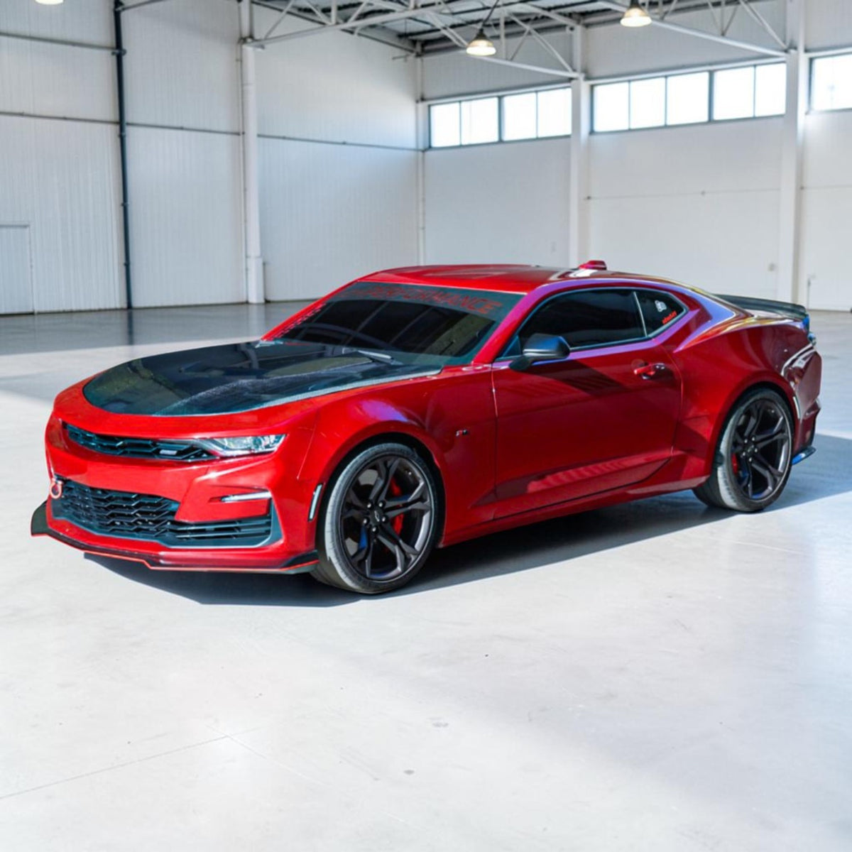 red 6th gen camaro with carbon fiber hood