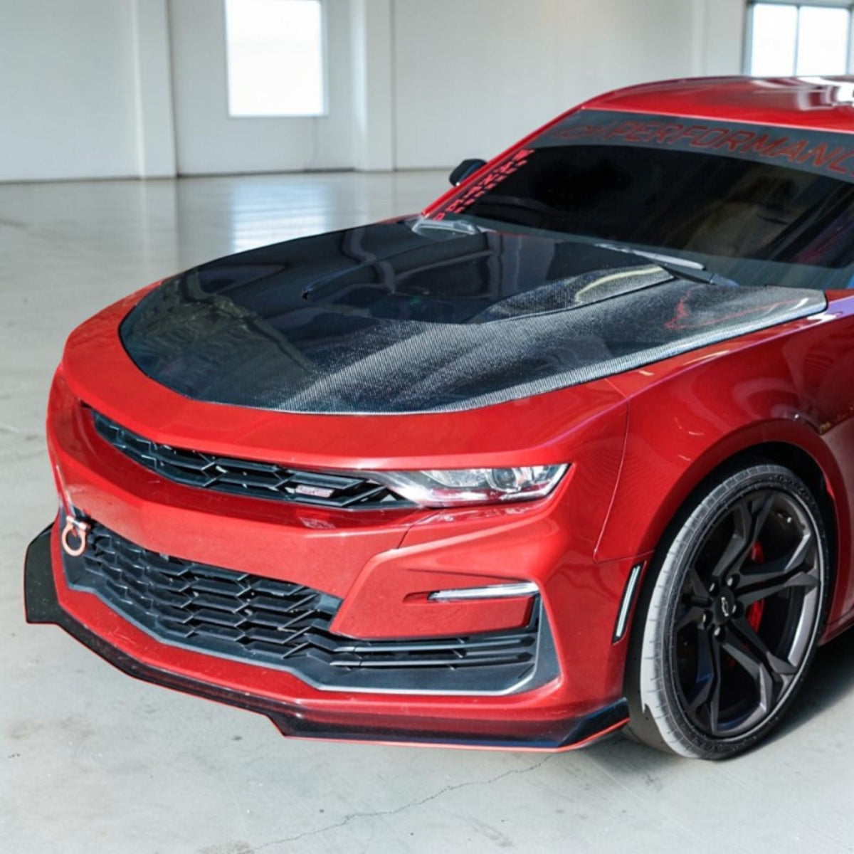 red 6th gen camaro with carbon fiber hood