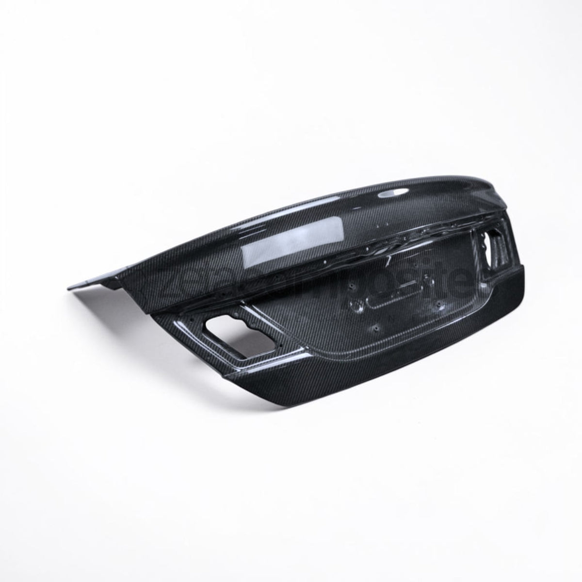Carbon fiber trunk lid corner detail with vented openings and trim cutouts