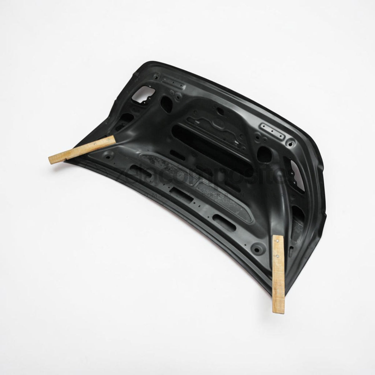 Underside of carbon fiber trunk lid, mounting holes and metal brackets visible