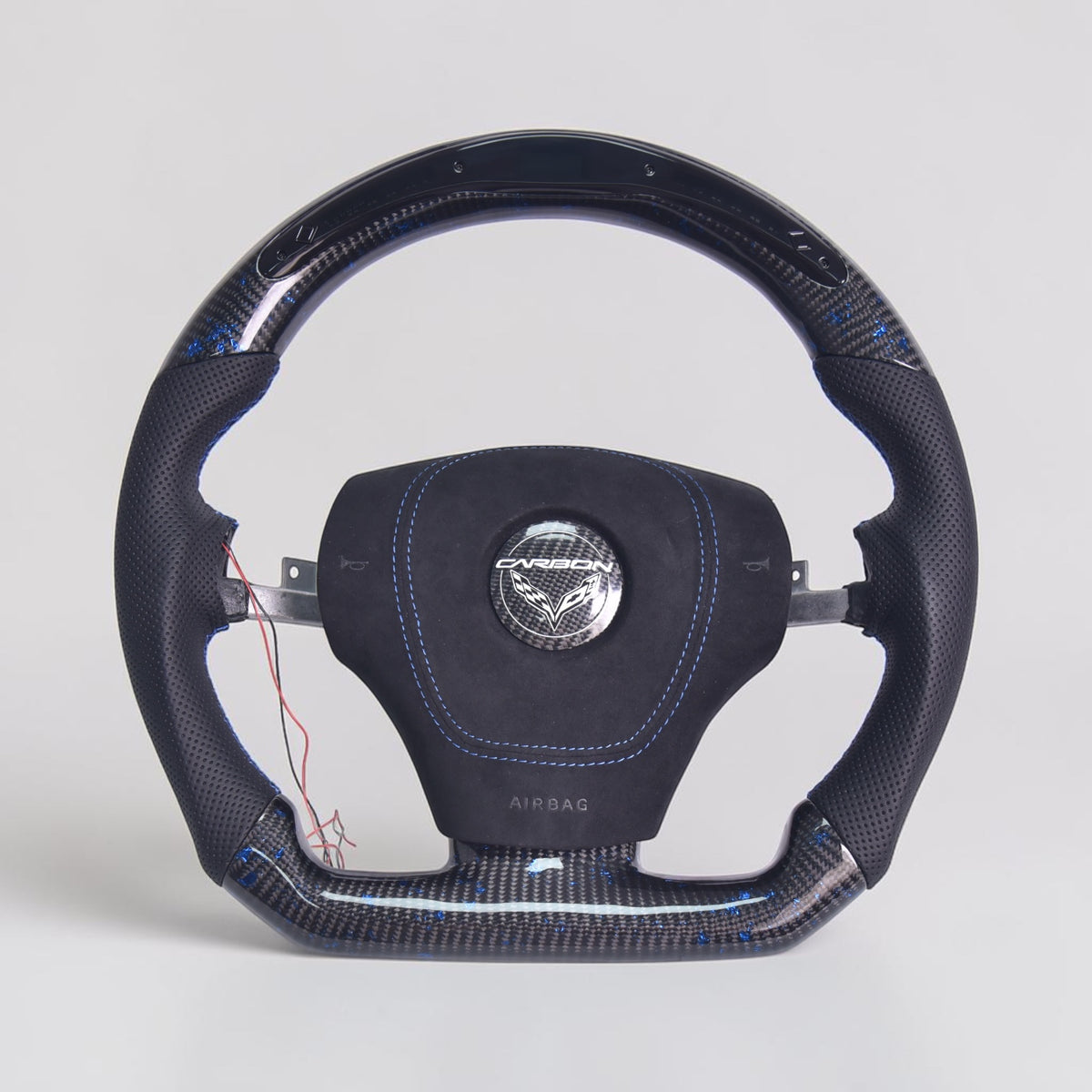 C6 Corvette carbon fiber steering wheel with perforated grips and blue stitching