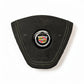 A black suede or Alcantara steering wheel cover with light contrast stitching and a central chrome-embellished Cadillac crest badge, shown on a white background.