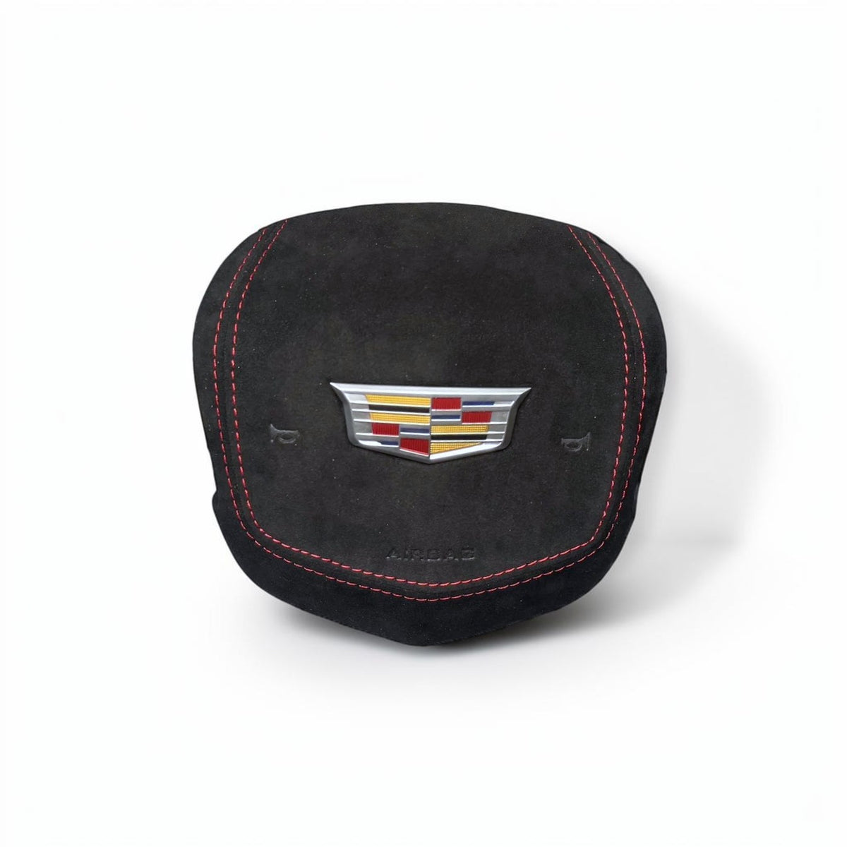 A black suede cover featuring red contrast stitching and a silver Cadillac crest emblem in the center, set against a plain white background.