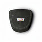 A black suede or nubuck airbag cover featuring white contrast stitching, a metallic Cadillac crest badge, and the word 'AIRBAG' printed below, shown on a white background with a soft drop shadow.