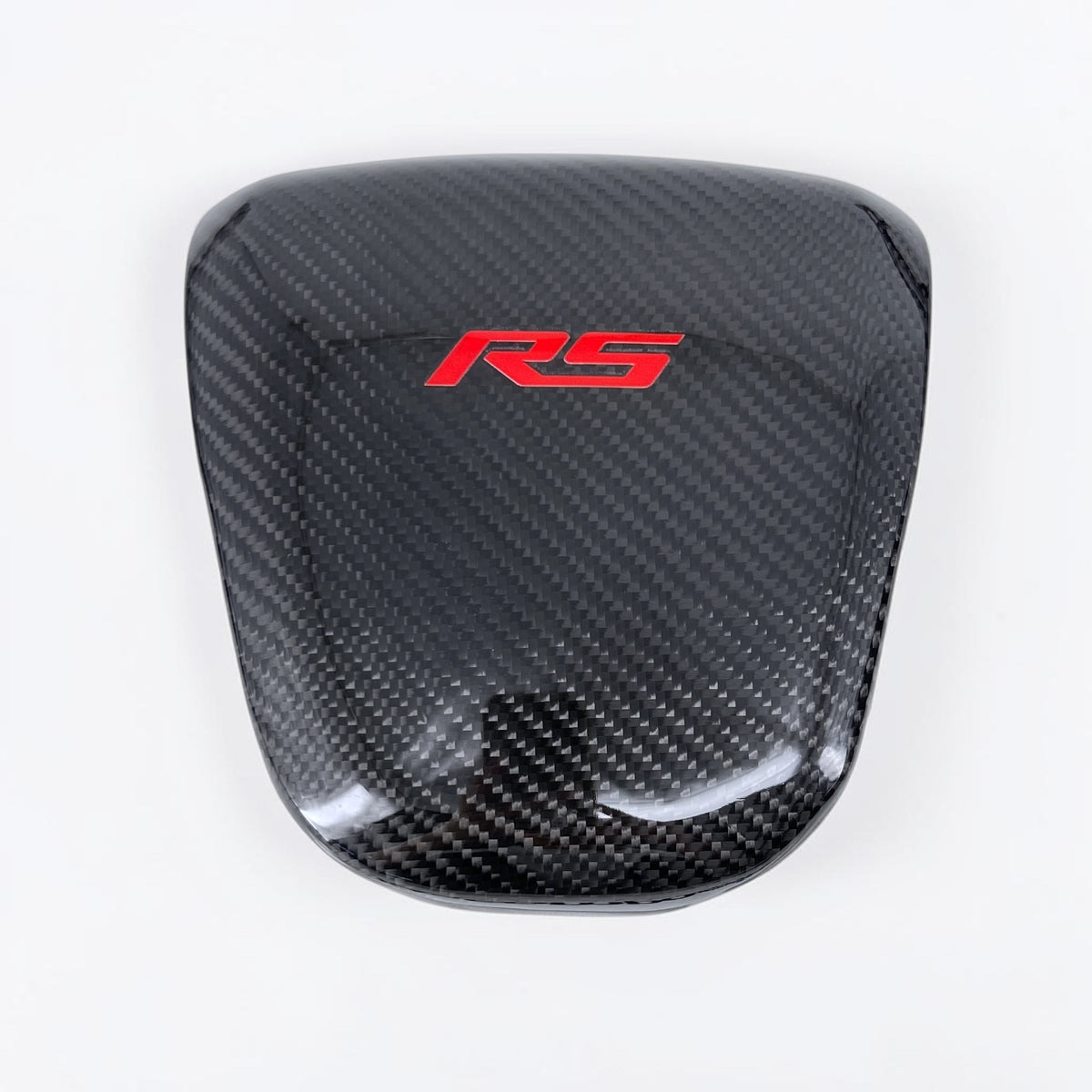 Camaro airbag cover with dark carbon fiber pattern and red RS emblem