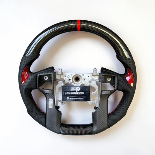 Carbon fiber steering wheel cover with perforated grip, red accents, visible mounting plate