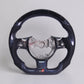 Custom carbon fiber steering wheel with blue accents and exposed center mounting hub