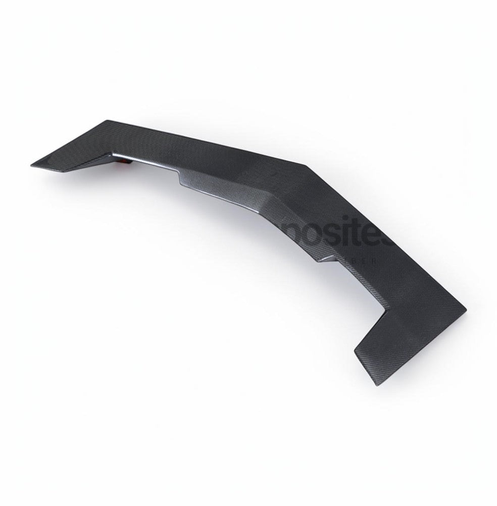 A black carbon fiber textured automotive spoiler or body trim piece, shown from a three-quarters perspective on a clean white background.