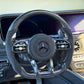 Carbon-fiber steering wheel upgrade with black leather grip and Mercedes logo center