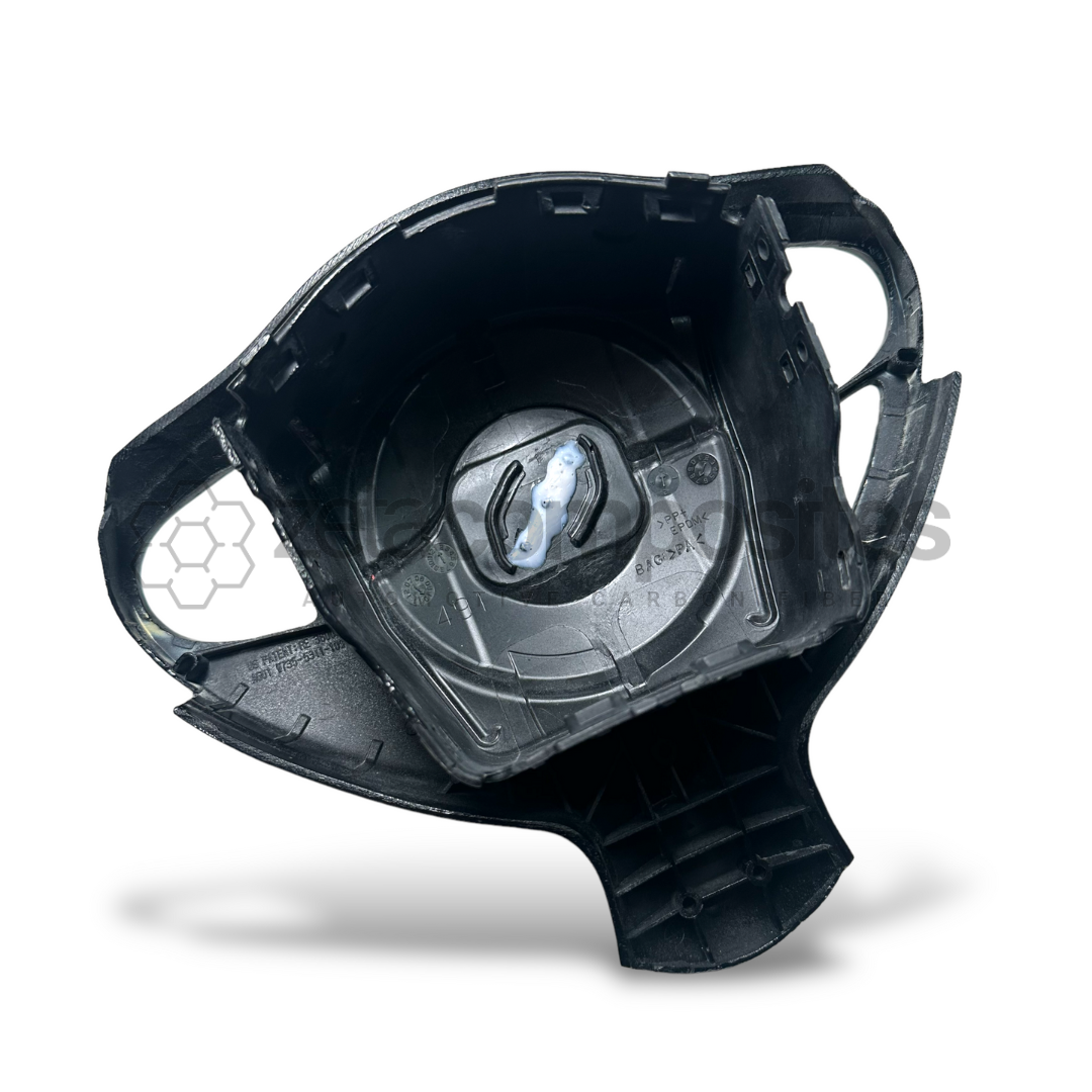 Steering wheel airbag cover back with molded black housing and mounting tabs