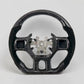 Dodge Ram steering wheel with a glossy carbon fiber finish and exposed central mounting hub