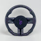 Carbon fiber steering wheel with black grips and purple-speckle accents