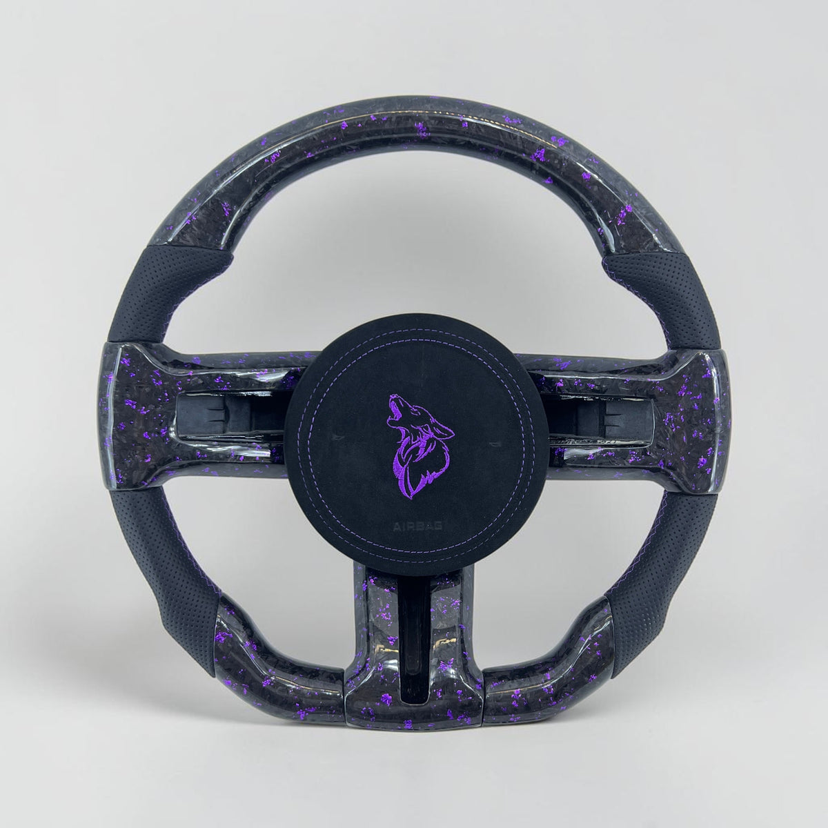 Carbon fiber steering wheel with black grips and purple-speckle accents